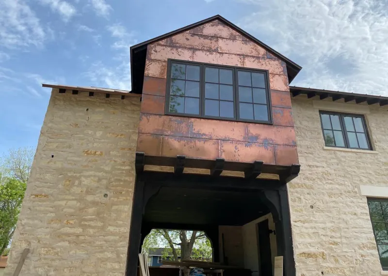 Copper metal panel facade on a stone building for Skylight Installation in Hidden Valley Lake